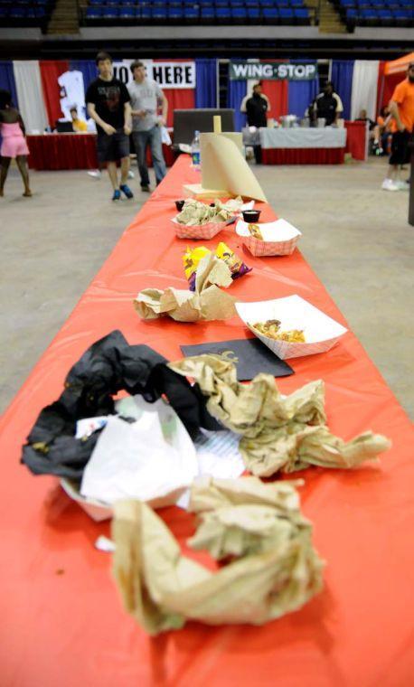 Used napkins, bare bones and other trash is strewn about a table Saturday, April 26, 2014 during the first annual Louisiana Wing-a-thon at the Baton Rouge River Center.