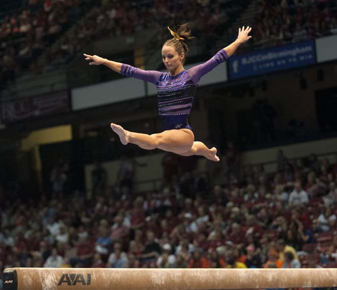 LSU junior all-around gymnast Jessie Jordan jumps on the beam Saturday, April 19, 2014 during the second rotation of the NCAA Super Six Finals in Birmingham, Ala.