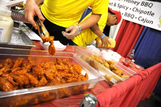 Event workers prepare wings for hungry attendees Saturday, April 26, 2014 during the first annual Louisiana Wing-a-thon at the Baton Rouge River Center.