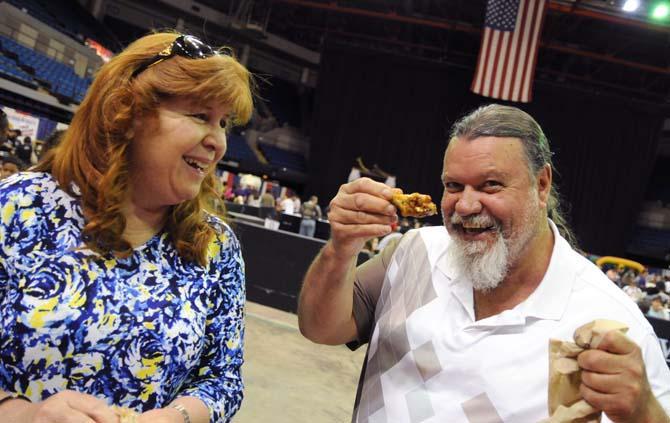 Two event attendees enjoy wings together Saturday, April 26, 2014 during the first annual Louisiana Wing-a-thon at the Baton Rouge River Center.