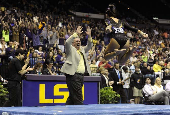 LSU gymnastics assistant coach Bob Moore celebrates with freshman all-around Ashleigh Gnat following her vault Saturday, April 5, 2014 in the PMAC. The Tigers posted a 198.325 score in the NCAA Gymnastics Regional to advance to the NCAA Championship.