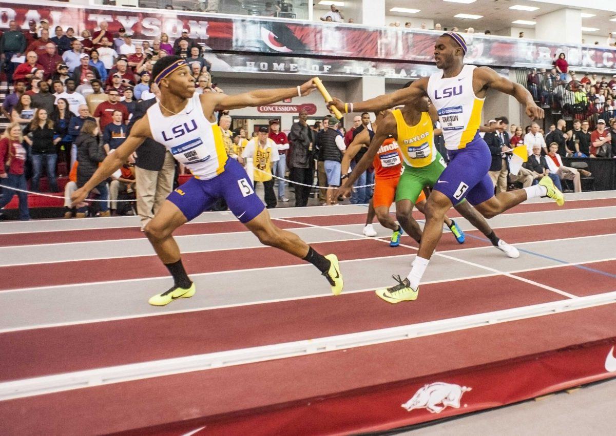 LSU's Cyril Grayson, right, hands off the baton to teammate Darrell Bush, left, on the final exchange of the 4x400-meter relay at the NCAA Division I Indoor Track and Field Championship in Fayetteville, Ark., Saturday, March 9, 2013. (AP Photo/April L. Brown)