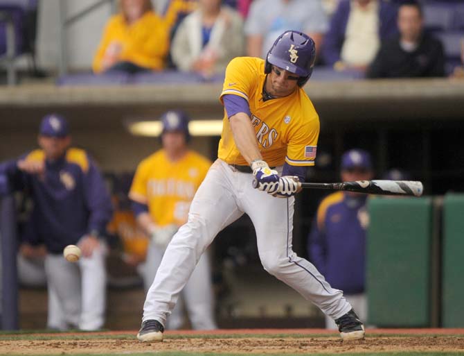 LSU junior infielder Tyler Moore (2) hits the ball Sunday, April 6, 2014 during the Tigers' 17-4 victory against Mississippi State at Alex Box Stadium.