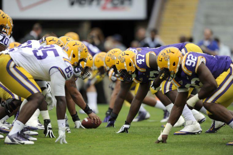 The white and purple squads line up at the line of scrimmage Saturday, April 5, 2014 during the white squad's 42-14 victory against the purple squad in the National L Club Spring Game in Tiger Stadium.