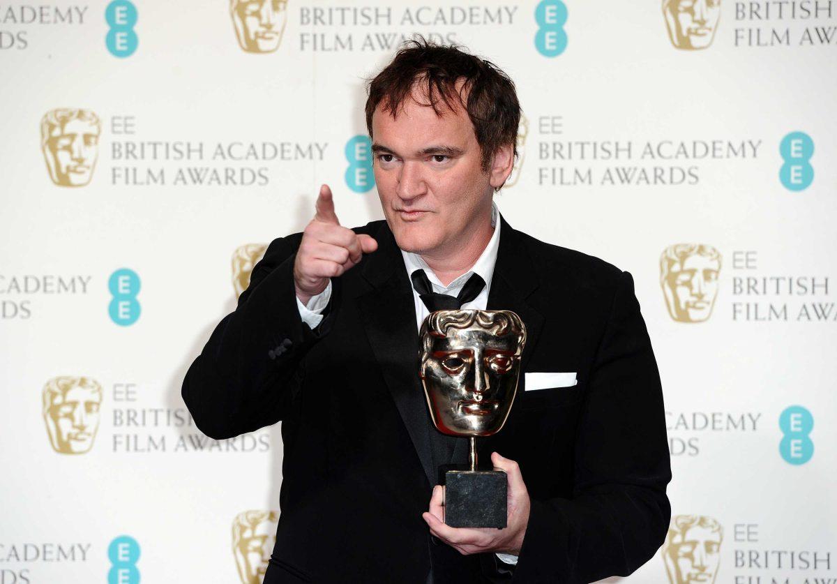 Writer-director Quentin Tarantino holds the award for best Original Screenplay for "Django Unchained," at the BAFTA Film Awards at the Royal Opera House on Sunday, Feb. 10, 2013, in London. (Photo by Jonathan Short/Invision/AP)