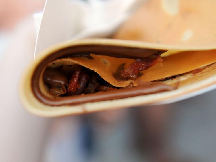 A festivalgoer purchases a Nutella and bacon crepe Saturday, April 26, 2014 at the annual Festival International de Louisiane in Downtown Lafayette.