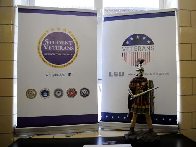 A poster is set up Friday, April 25, 2014, during the opening of the new Veteran Student Center in Hatcher Hall.