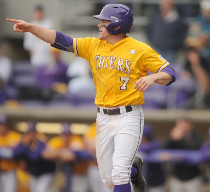 LSU senior outfielder Sean McMullen (7) points at his teammates Sunday, April 6, 2014 during the Tigers' 17-4 victory against Mississippi State at Alex Box Stadium.