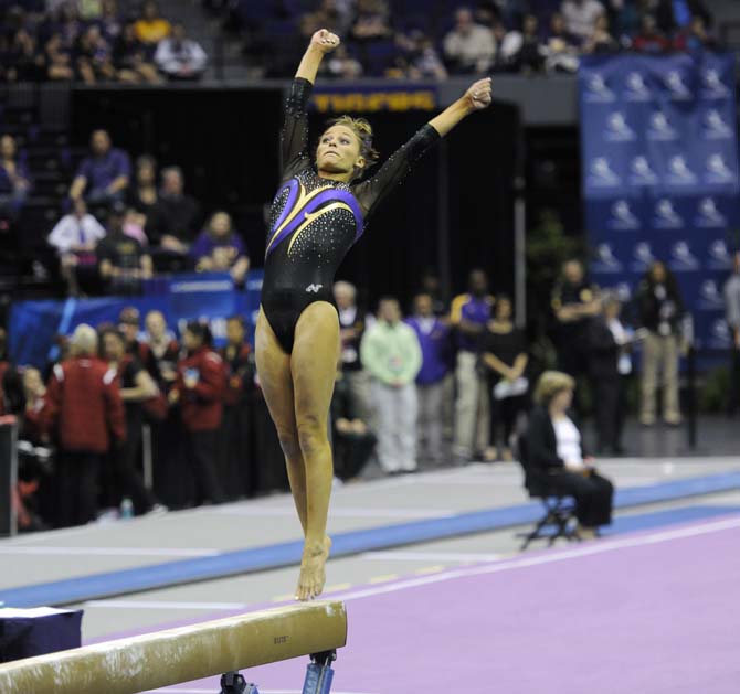 LSU junior all-around Jessie Jordan leaps off the beam Saturday, April 5, 2014, during an NCAA Gymnastics Regional meet in the PMAC. The Tigers won the meet with a school-record score of 198.325.