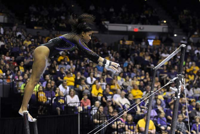 LSU sophomore all-around Randii Wyrick jumps between uneven bars Saturday, April 5, 2014, during an NCAA Gymnastics Regional meet in the PMAC. The Tigers won the meet with a school-record score of 198.325.