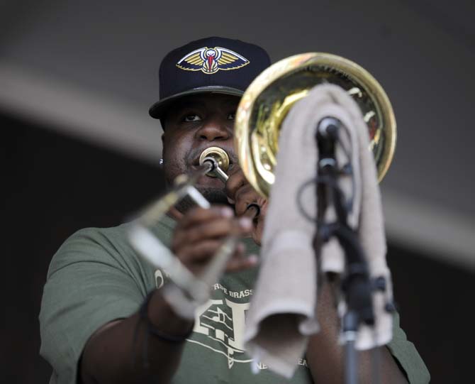 A member of the Young Pinstripe Brass Band performs Sunday, April 27, 2014, during the New Orleans Jazz and Heratige Festival.