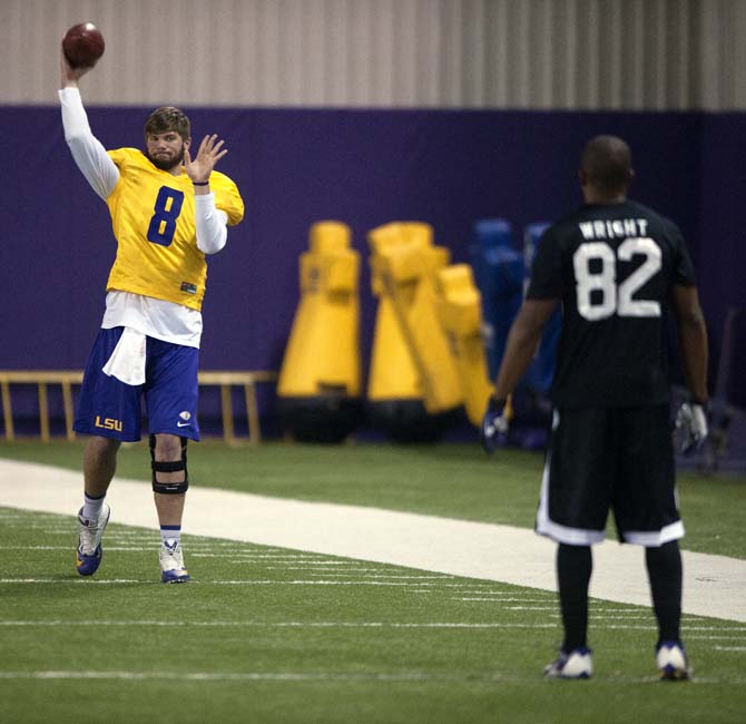 LSU senior quarterback Zach Mettenberger (8) warms up during LSU Pro Day on Wednesday, April 9, 2014 in the LSU Indoor Practice Facility.