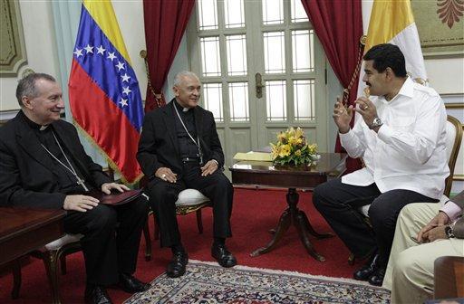 CORRECTS POSITION OF TWO MEN AT LEFT - FILE - In this June 14, 2013 file photo, Venezuela's President Nicolas Maduro, right, meets with Venezuela's Archbishop Diego Rafael Padron Sanchez, center, and Italian Pietro Parolin, Holy See's representative in Venezuela, at Miraflores presidential palace in Caracas, Venezuela. Padron, speaking in Caracas on Wednesday, April 2, 2014, accused Maduro of attempting to criminalize dissent. Venezuela's organization of Catholic bishops is accusing the government of seeking totalitarian-style rule, comments that potentially could complicate the Vatican's offer to facilitate talks between the socialist government and its opposition. (AP Photo/Ariana Cubillos, File)