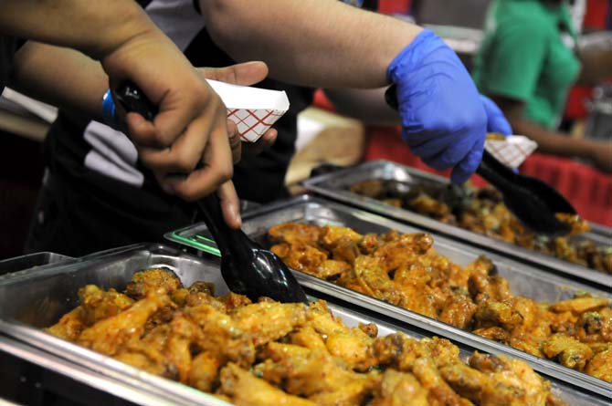 Event workers prepare wings for hungry attendees Saturday, April 26, 2014 during the first annual Louisiana Wing-a-thon at the Baton Rouge River Center.