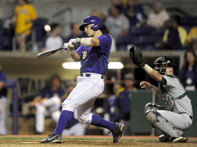 LSU junior outfielder Chris Chinea (5) tips a ball Tuesday, April 22, 2014, during the Tigers' 6-0 win against Tulane in Alex Box Stadium.