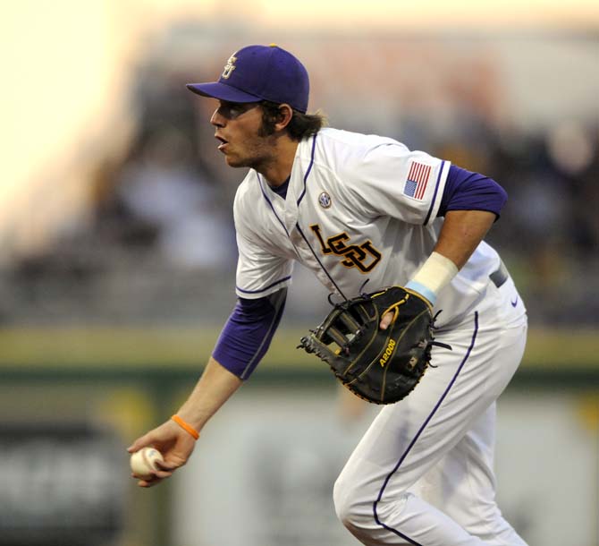 LSU junior infielder Connor Hale tosses to first on Friday, April 25, 2014 during the Tigers' 8-7 victory against Tennessee at Alex Box Stadium.