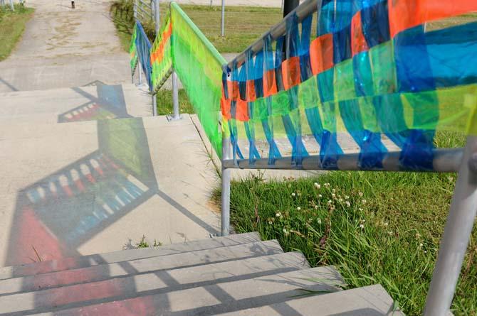 The sun reflects colorful designs on the ground Tuesday, April 29, 2014 on the levee.