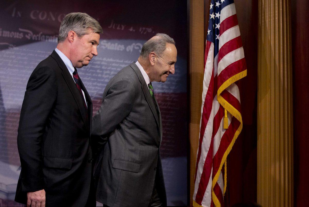 Sen. Charles Schumer, D-N.Y., right, followed by Sen. Sheldon Whitehouse, D-R.I. leave a news conference on Capitol Hill in Washington, Wednesday, April 2, 2014, where they talked about the Supreme Court decision in the McCutcheon vs. FEC case, in which the Court struck down limits in federal law on the aggregate campaign contributions individual donors may make to candidates, political parties, and political action committees. (AP Photo/Manuel Balce Ceneta)