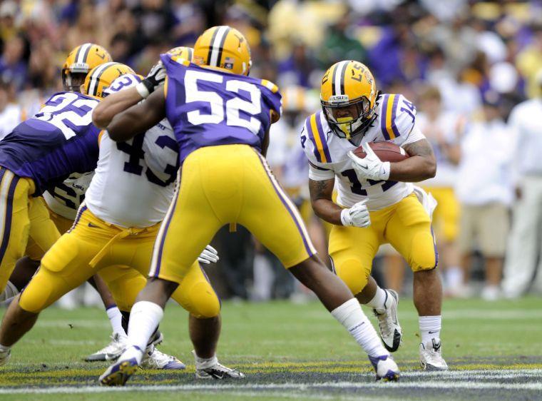 LSU senior runningback Terrence Magee (14) runs downfield Saturday, April 5, 2014 during the white squad's 42-14 victory against the purple squad in the National L Club Spring Game in Tiger Stadium.