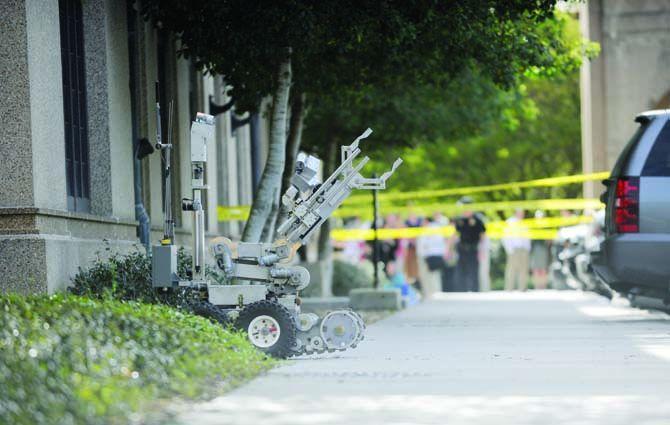 A bomb squad robot is sent to examine the suspicious package near Thomas Boyd Hall Monday, April 7, 2014.