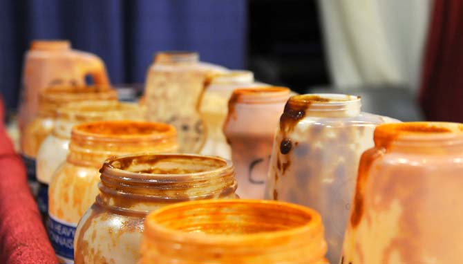 Empty bottles of wing sauce sit on a table near a booth Saturday, April 26, 2014 during the first annual Louisiana Wing-a-thon at the Baton Rouge River Center.