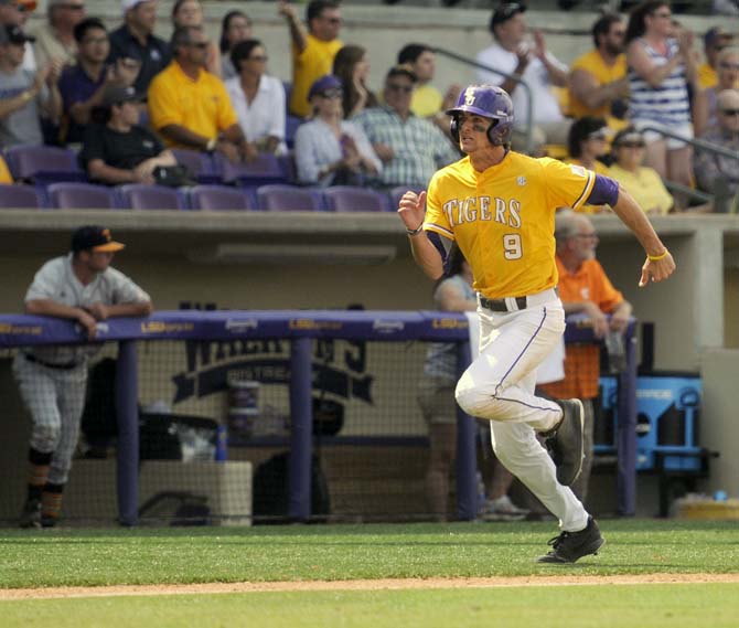 LSU sophomore outfielder Mark Laird (9) runs to home plate Sunday, April 27, 2014, during the Tigers' 9-4 victory against Tennessee in Alex Box Stadium.