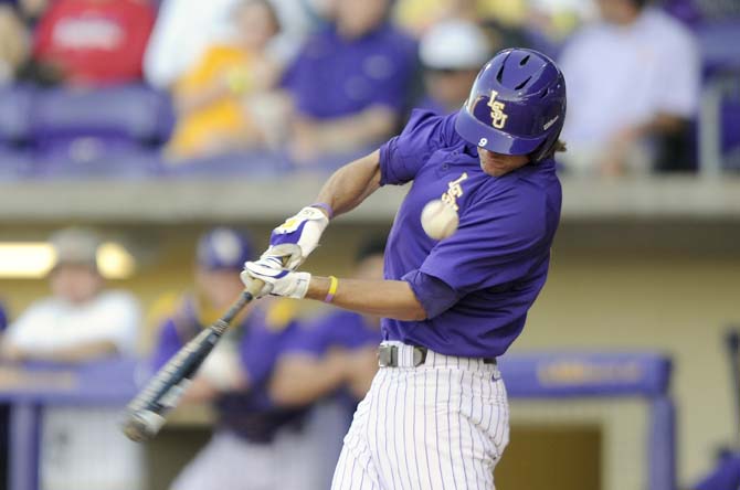 LSU sophomore outfielder Mark Laird (9) tips a ball foul Tuesday, April 22, 2014, during the Tigers' 6-0 win against Tulane in Alex Box Stadium.