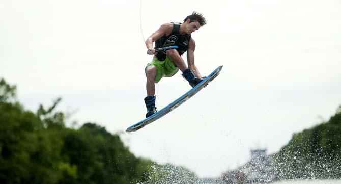 LSU wakeboarder Kyle Jordan grabs his wakeboard while doing a trick Wednesday, April 30, 2014, in the Gulf Intracoastal Waterway.