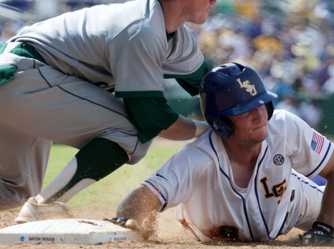 LSU sophomore infielder Alex Bregman (8) slides back to first base as a Southeastern first baseman catches the ball Friday, May 30, 2014 during the Tigers' 8-4 victory against the Lions in Alex Box Stadium.