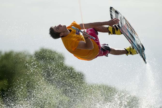 LSU wakeboarder Nick Vaccari grabs his wakeboard while doing a trick Wednesday, April 30, 2014, in the Gulf Intracoastal Waterway.