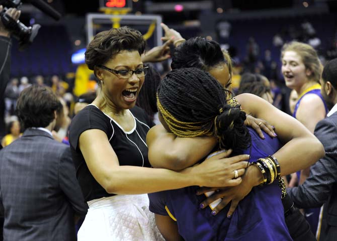 LSU women's basketball head coach Nikki Caldwell celebrates with assistant coach Tasha Butts and freshman guard Jasmine Rhodes on Tuesday, March 25, 2014 after the Tigers' 76-67 victory against West Virginia in the PMAC.