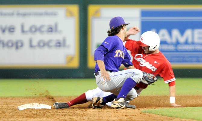 LSU then-freshman infielder Kramer Robertson (3) attempts to tag a Houston runner out at second base Saturday, May 31, 2014 during the Tigers' 5-1 victory against the Cougars in Alex Box Stadium.