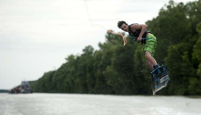 LSU wakeboarder Kyle Jordan does a trick Wednesday, April 30, 2014, in the Gulf Intracoastal Waterway.