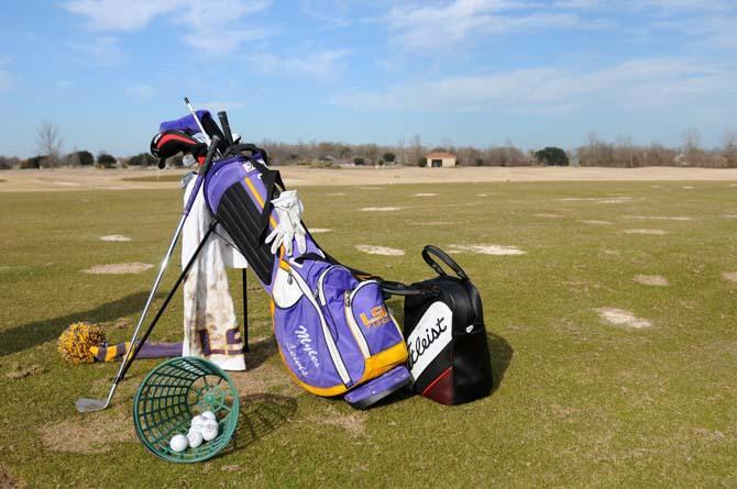 Junior golfer Myles Lewis sets up his equipment for practice Monday, Jan. 20, 2014 at the University Club golf course.