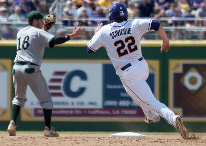 LSU junior catcher Kade Scivicque (22) rounds second base as Southeastern Louisiana freshman infielder Kennon Menard looks towards the outfield Friday, May 30, 2014 during the Tigers' 8-4 victory against the Lions in Alex Box Stadium.