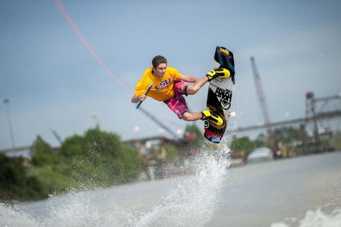 LSU wakeboarder Nick Vaccari grabs his wakeboard while doing a trick Wednesday, April 30, 2014, in the Gulf Intracoastal Waterway.