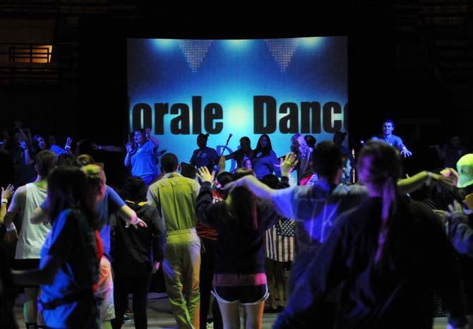 Students and event staff participate in a "morale dance" at the top of the hour Saturday, Feb. 22, 2014 at the Dance Marathon event in the John M. Parker Coliseum.