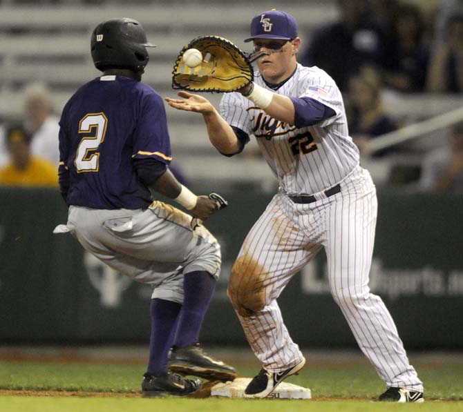 LSU junior catcher Kade Scivicque (22) catches the ball at first base Tuesday, April 29, 2014, during the Tigers' 9-7 victory against Alcorn in Alex Box Stadium.