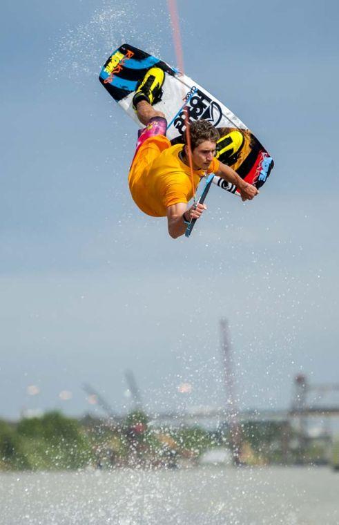 LSU wakeboarder Nick Vaccari grabs his wakeboard while doing a trick Wednesday, April 30, 2014, in the Gulf Intracoastal Waterway.