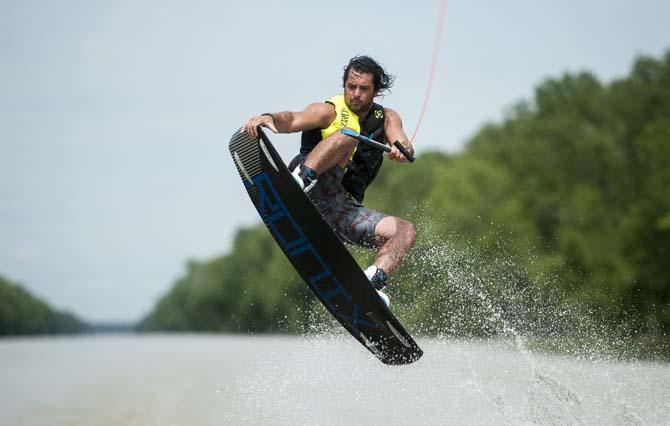 LSU wakeboarder Jordan Hughes grabs his wakeboard Wednesday, April 30, 2014, in the Gulf Intracoastal Waterway.