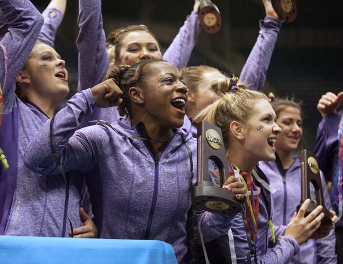 LSU junior all-around gymnast Lloimincia Hall celebrates with teammates Saturday, April 19, 2014 after placing third at the NCAA Super Six Finals in Birmingham, Ala. The Lady Tigers received a score of 197.600. Florida and Oklahoma tied for first place with a score of 198.175.