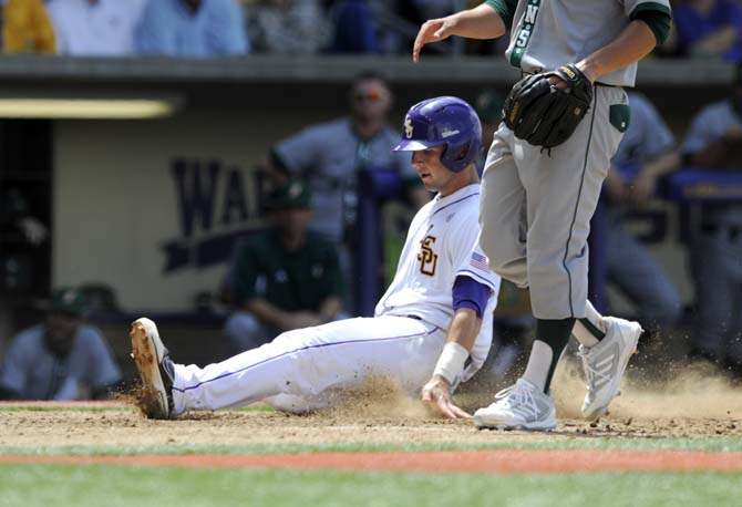 LSU junior infielder Tyler Moore (2) slides into home plate Friday, May 30, 2014 during the Tigers' 8-4 victory against Southeastern Louisiana in Alex Box Stadium.