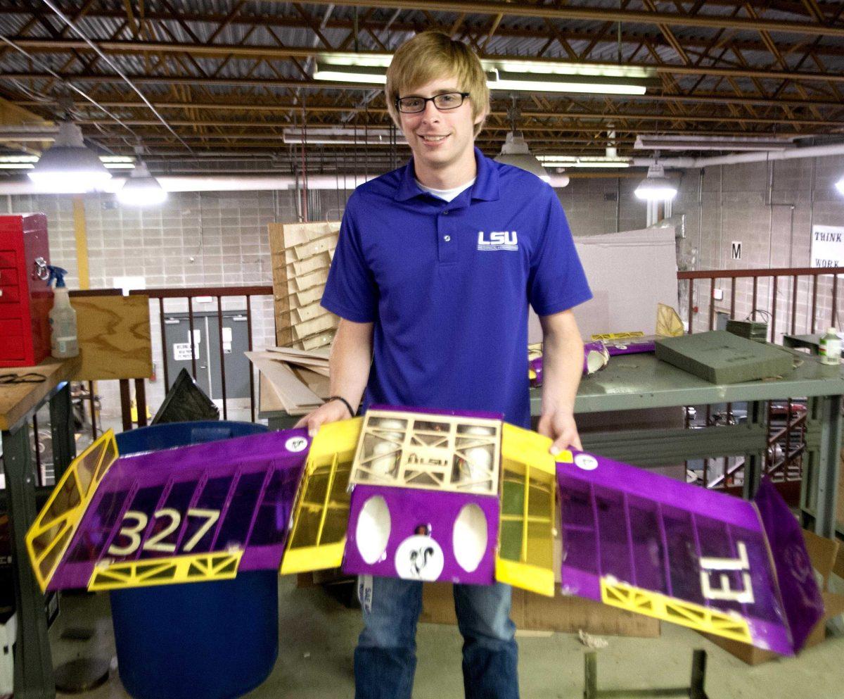 LSU engineering senior Sean King holds his team's capstone project. The design is the 2014 SAE Aero Design West Micro Class Aircraft.