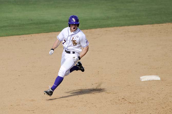 LSU senior outfielder Sean McMullen (7) celebrates as he rounds second base Friday, May 30, 2014 during the Tigers' 8-4 victory against Southeastern Louisiana in Alex Box Stadium.