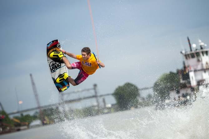 LSU wakeboarder Nick Vaccari grabs his wakeboard while doing a trick Wednesday, April 30, 2014, in the Gulf Intracoastal Waterway.