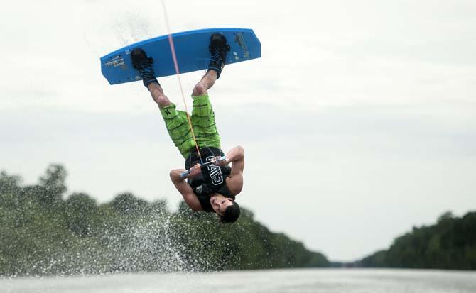 LSU wakeboarder Kyle Jordan flips on his wakeboard while doing a trick Wednesday, April 30, 2014, in the Gulf Intracoastal Waterway.