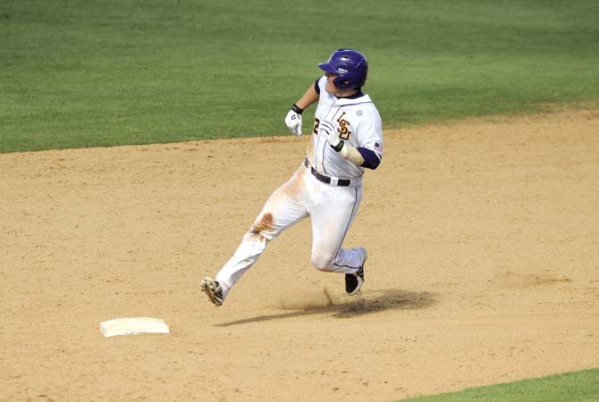 LSU junior catcher Kade Scivicque (22) prepares to round second base Friday, May 30, 2014 during the Tigers' 8-4 victory against Southeastern Louisiana in Alex Box Stadium.