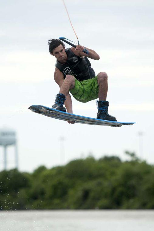 LSU wakeboarder Kyle Jordan grabs his wakeboard while doing a trick Wednesday, April 30, 2014, in the Gulf Intracoastal Waterway.