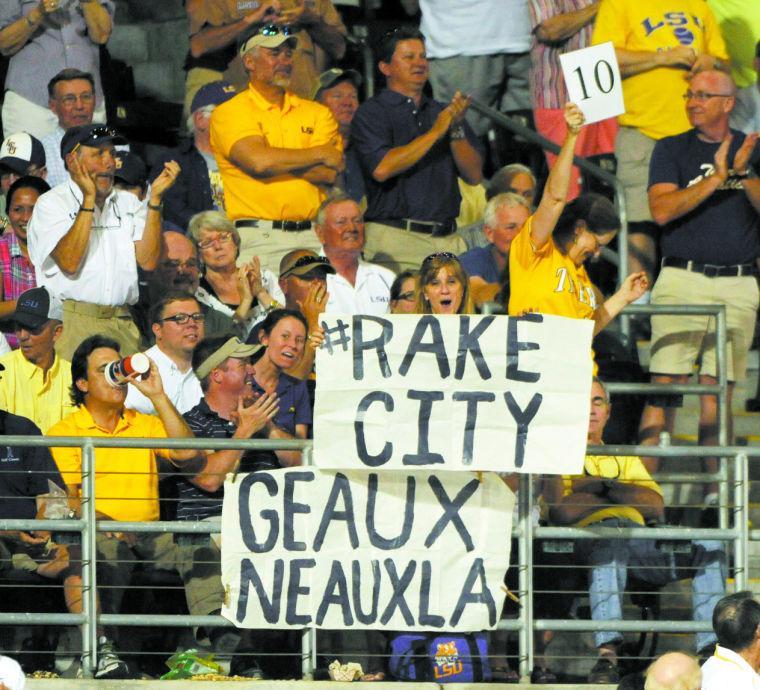 LSU fans display signs Friday, April 25, 2014 during the Tigers' 8-7 victory against Tennessee at Alex Box Stadium.