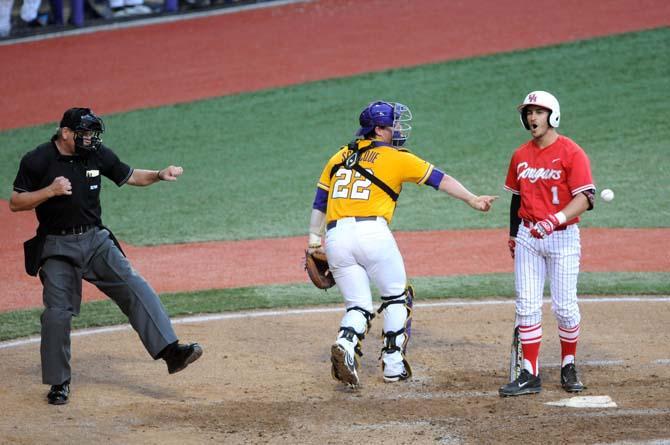 LSU junior catcher Kade Scivicque (22) throws the ball back to the pitcher after receiving the pitch that struck Houston senior outfielder Landon Appling (1) out Monday, April 2, 2014 during the Tigers' 12-2 loss against the Cougars in Alex Box Stadium.